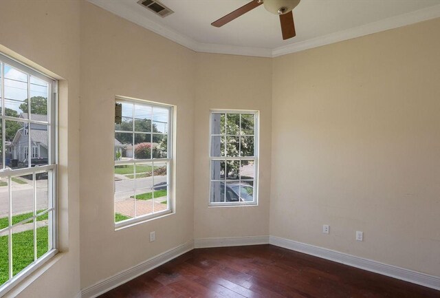 5106 Baccich St, New Orleans, LA 70122 - empty room featuring healthy amount of natural light, dark wood-type flooring, baseboards, and ornamental molding
