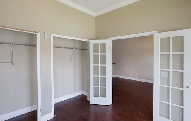 5106 Baccich St, New Orleans, LA 70122 - unfurnished bedroom featuring two closets, wood finished floors, crown molding, baseboards, and french doors