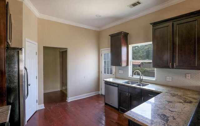 5106 Baccich St, New Orleans, LA 70122 - kitchen with appliances with stainless steel finishes, a sink, dark wood-style flooring, dark brown cabinetry, and ornamental molding