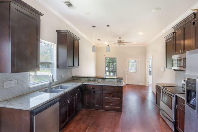 5106 Baccich St, New Orleans, LA 70122 - kitchen with appliances with stainless steel finishes, a sink, a peninsula, ceiling fan, and dark wood-style floors