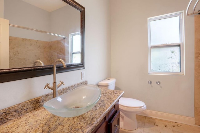 5106 Baccich St, New Orleans, LA 70122 - bathroom with toilet, vanity, a shower, and baseboards