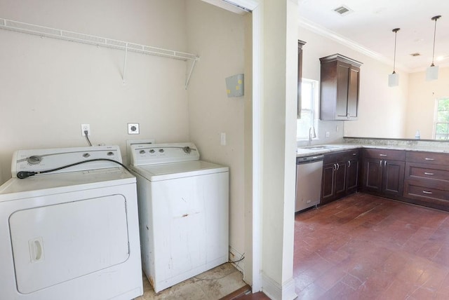 5106 Baccich St, New Orleans, LA 70122 - laundry area with washing machine and clothes dryer and crown molding