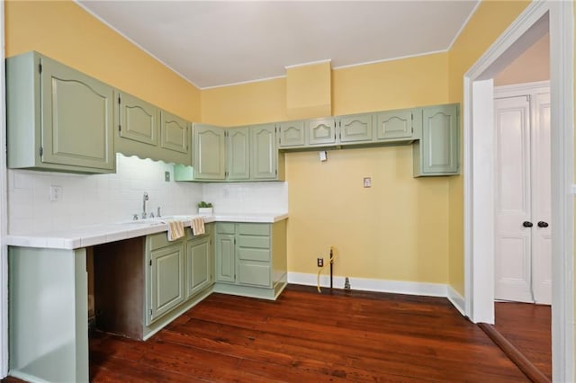 kitchen featuring tile countertops, dark wood-style flooring, and green cabinets