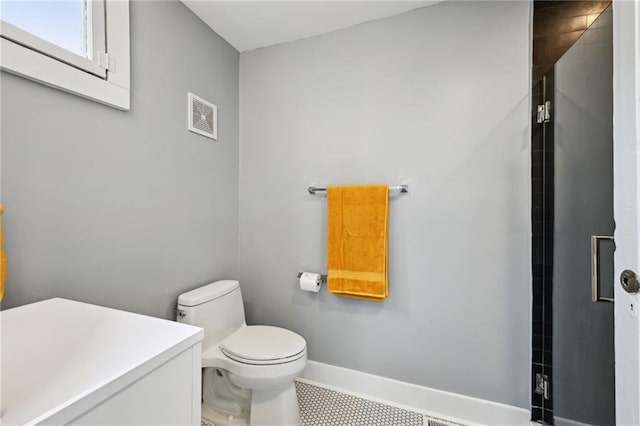 bathroom featuring toilet and baseboards
