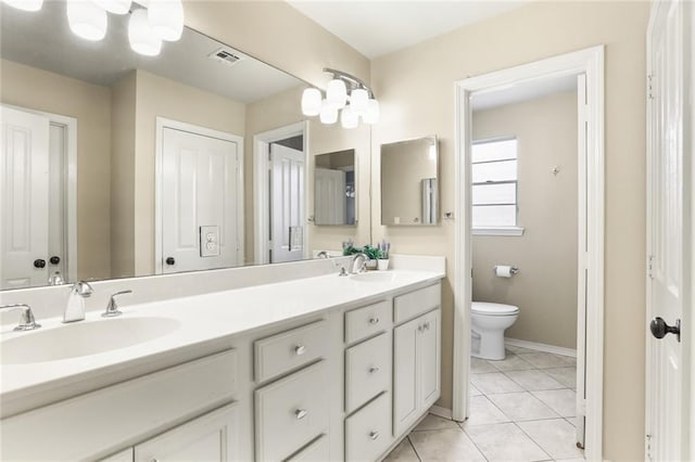 full bath with toilet, double vanity, baseboards, and tile patterned floors