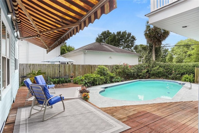 view of pool featuring a deck, a fenced backyard, and a patio