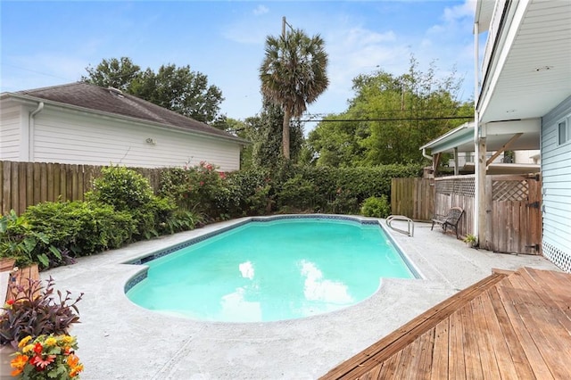 view of swimming pool with a fenced backyard and a patio area