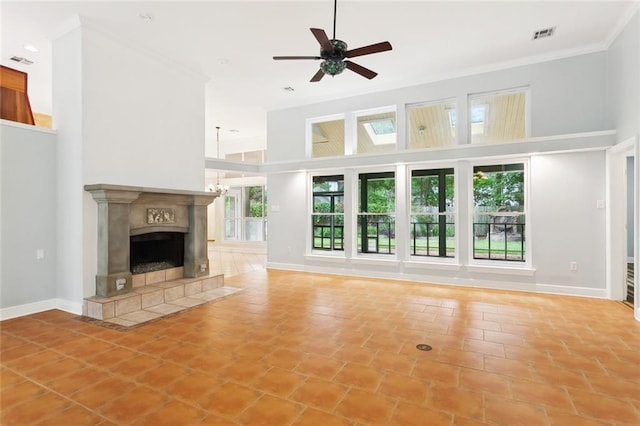 1306 Woodmere Dr, Mandeville, LA 70471 - unfurnished living room featuring a high ceiling, light tile patterned flooring, ceiling fan, a tiled fireplace, and ornamental molding