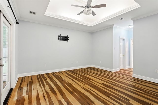 1306 Woodmere Dr, Mandeville, LA 70471 - unfurnished room with wood-type flooring, a raised ceiling, crown molding, baseboards, and a ceiling fan