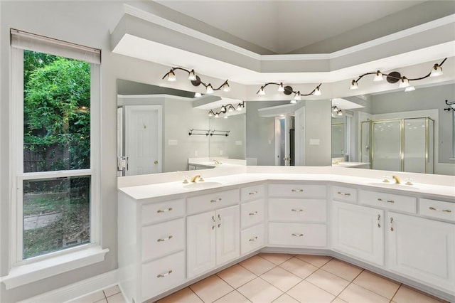 1306 Woodmere Dr, Mandeville, LA 70471 - bathroom featuring tile patterned floors, a shower stall, double vanity, and vaulted ceiling