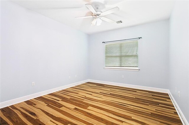 1306 Woodmere Dr, Mandeville, LA 70471 - spare room with baseboards, wood finished floors, and a ceiling fan