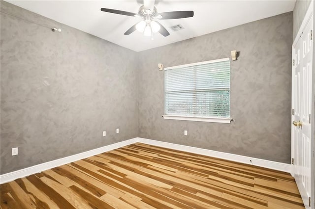 1306 Woodmere Dr, Mandeville, LA 70471 - unfurnished room with wood finished floors, a ceiling fan, and baseboards