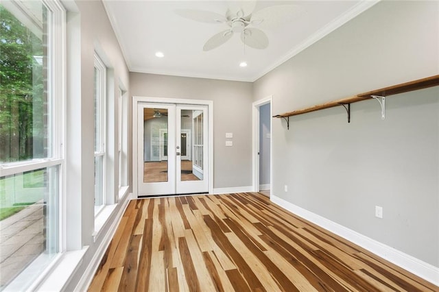 1306 Woodmere Dr, Mandeville, LA 70471 - unfurnished room with a ceiling fan, french doors, crown molding, baseboards, and light wood finished floors