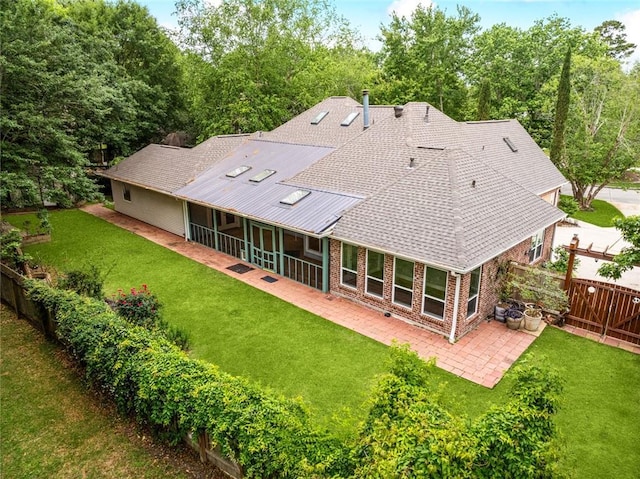 1306 Woodmere Dr, Mandeville, LA 70471 - rear view of house with a patio, brick siding, a sunroom, and roof with shingles