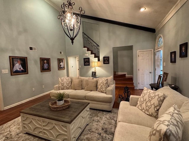 208 Noble Dr, Brookhaven, MS 39601 - living room with stairway, ornamental molding, dark wood-type flooring, a chandelier, and baseboards