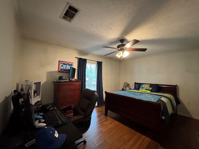 208 Noble Dr, Brookhaven, MS 39601 - bedroom featuring wood finished floors, an office area, a textured ceiling, and ceiling fan