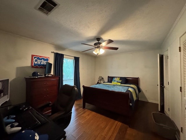 208 Noble Dr, Brookhaven, MS 39601 - bedroom with wood finished floors, a ceiling fan, a textured ceiling, a desk, and crown molding