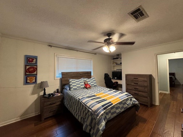 208 Noble Dr, Brookhaven, MS 39601 - bedroom with dark wood finished floors, a textured ceiling, baseboards, crown molding, and ceiling fan