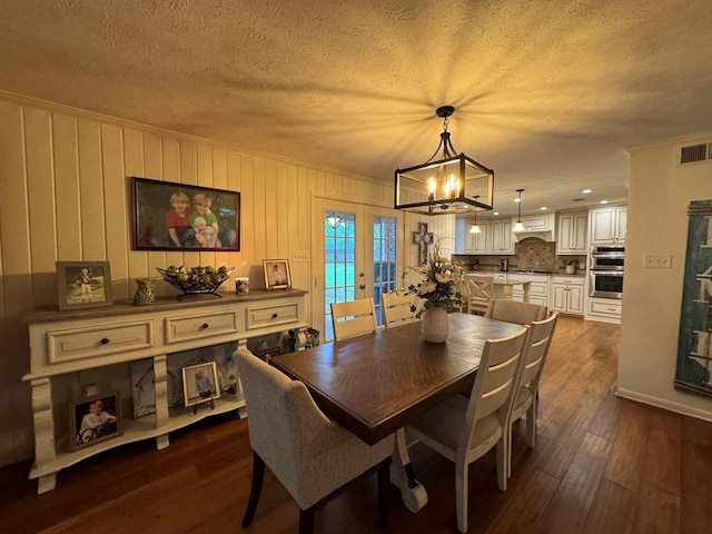 208 Noble Dr, Brookhaven, MS 39601 - dining area featuring a chandelier, dark wood-style floors, and a textured ceiling