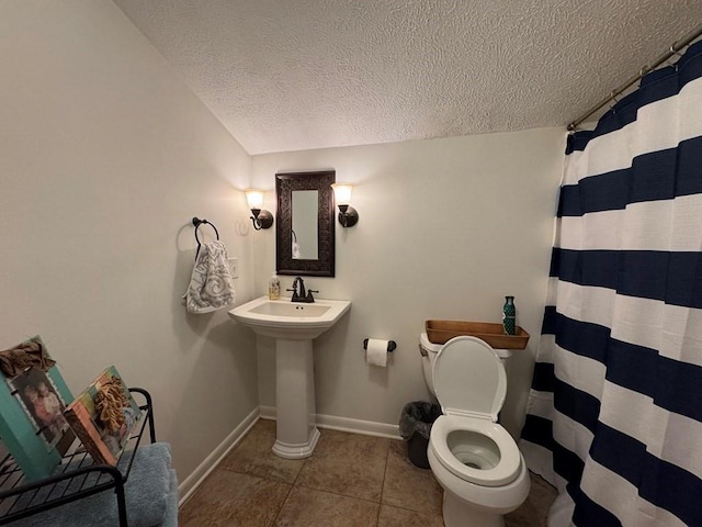 208 Noble Dr, Brookhaven, MS 39601 - full bath featuring a textured ceiling, tile patterned flooring, baseboards, toilet, and curtained shower