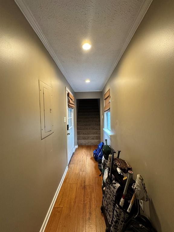 208 Noble Dr, Brookhaven, MS 39601 - hall with a textured ceiling, baseboards, light wood-style floors, crown molding, and electric panel