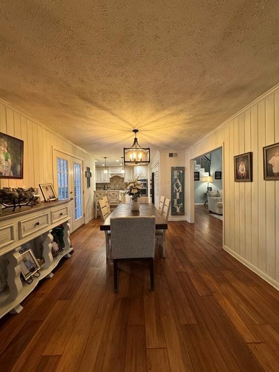 208 Noble Dr, Brookhaven, MS 39601 - dining space featuring a textured ceiling, a chandelier, dark wood-style floors, and baseboards