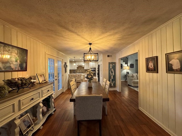 208 Noble Dr, Brookhaven, MS 39601 - dining room featuring a chandelier, dark wood finished floors, a textured ceiling, french doors, and ornamental molding