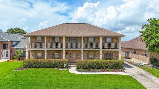 back of property featuring brick siding, cooling unit, a lawn, and a porch