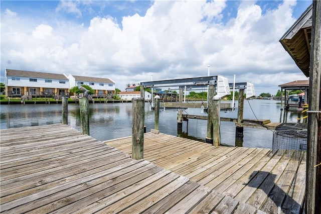 dock featuring boat lift and a water view