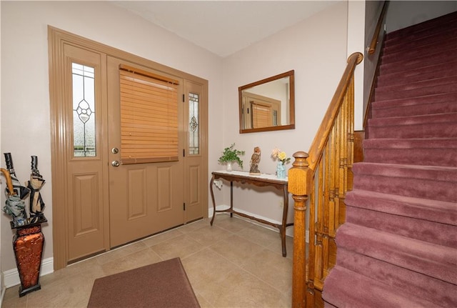 entryway featuring baseboards and stairs