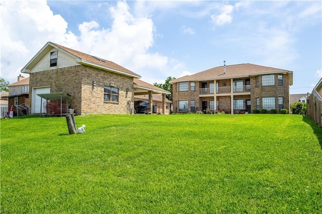 back of property with brick siding, a garage, and a yard