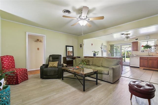 living area featuring ceiling fan, ornamental molding, and light wood-type flooring