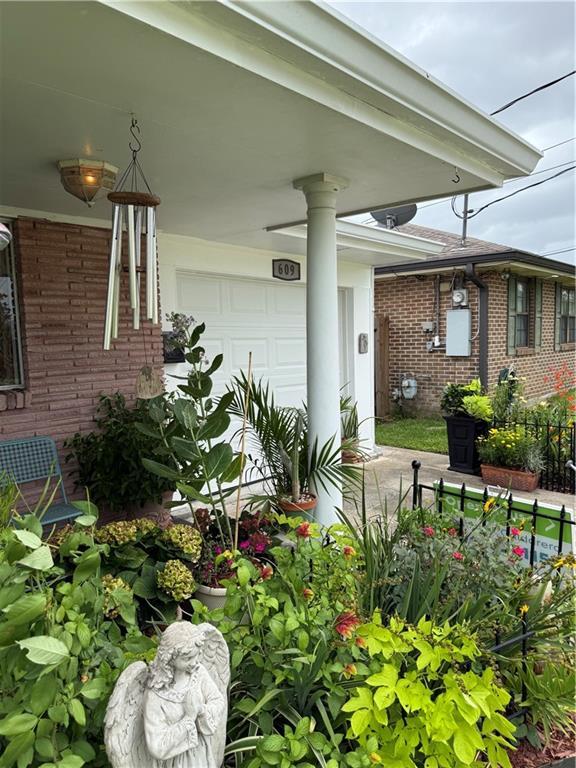 609 N Starrett Rd, Metairie, LA 70003 - property entrance featuring brick siding and a garage