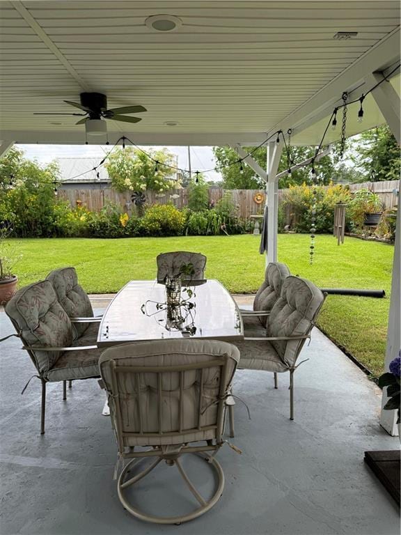 609 N Starrett Rd, Metairie, LA 70003 - fenced backyard featuring a patio, ceiling fan, and outdoor dining area