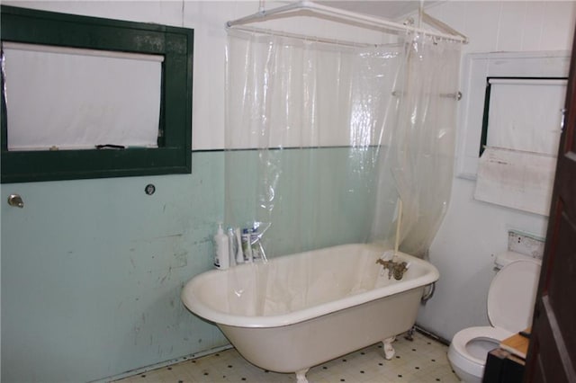 21508 Weinberger Rd, Ponchatoula, LA 70454 - full bathroom with tile patterned floors, toilet, a freestanding tub, and curtained shower