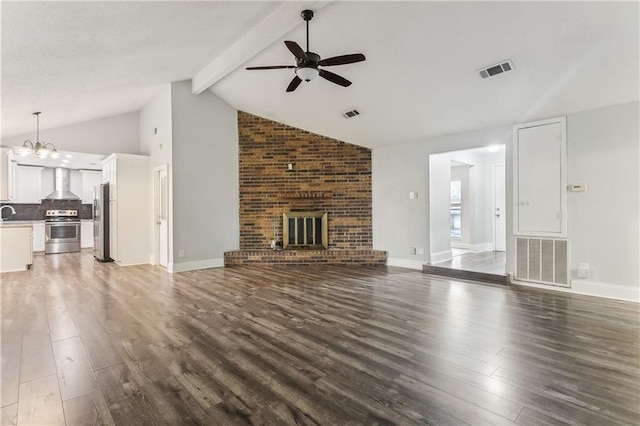 unfurnished living room with a ceiling fan, dark wood-style floors, a chandelier, and a fireplace