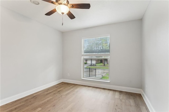 unfurnished room featuring wood finished floors, baseboards, and ceiling fan