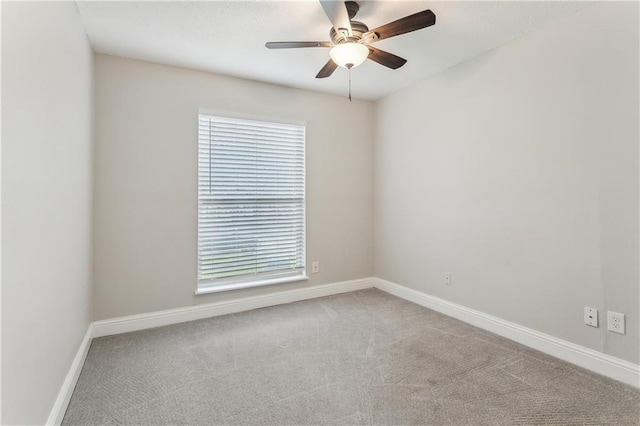 unfurnished room featuring healthy amount of natural light, carpet floors, a ceiling fan, and baseboards