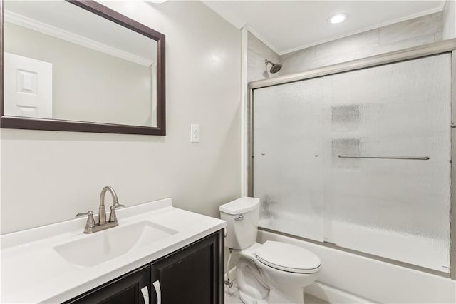bathroom featuring ornamental molding, toilet, vanity, enclosed tub / shower combo, and recessed lighting