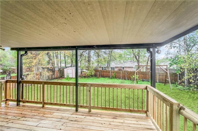 deck featuring a storage unit and an outbuilding