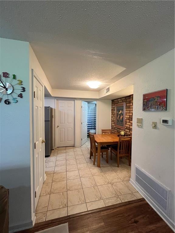2305 Cleary Ave Unit 106, Metairie, LA 70001 - dining area featuring a textured ceiling and light wood-style floors