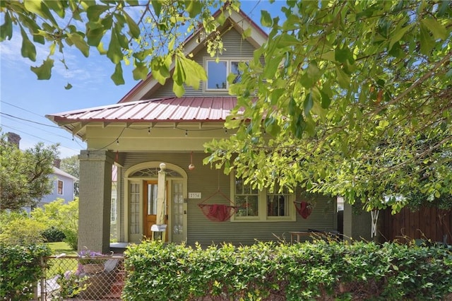 2334 Marengo St, New Orleans, LA 70115 - view of front of house featuring fence, metal roof, and covered porch
