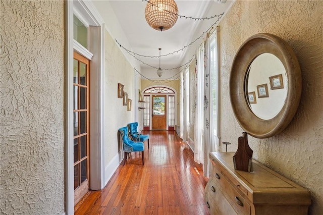 2334 Marengo St, New Orleans, LA 70115 - hall with a textured wall, hardwood / wood-style floors, french doors, and baseboards