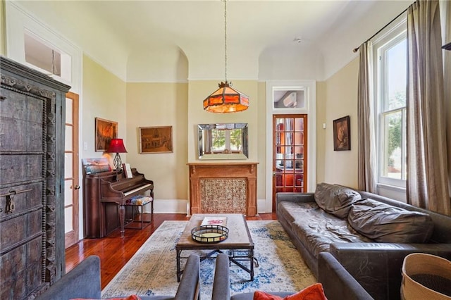 2334 Marengo St, New Orleans, LA 70115 - living area with wood finished floors, baseboards, and a tiled fireplace