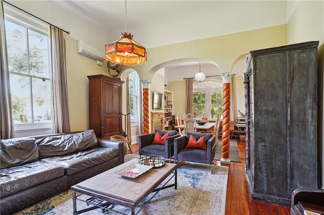 2334 Marengo St, New Orleans, LA 70115 - living area with arched walkways, hardwood / wood-style floors, an AC wall unit, and crown molding