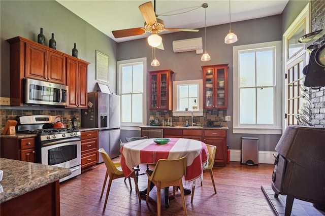2334 Marengo St, New Orleans, LA 70115 - kitchen featuring appliances with stainless steel finishes, plenty of natural light, glass insert cabinets, and dark wood-type flooring