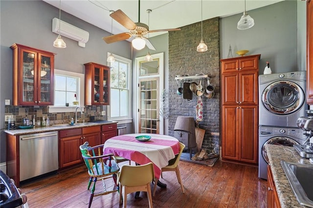 2334 Marengo St, New Orleans, LA 70115 - kitchen featuring stainless steel dishwasher, a sink, stacked washer / dryer, a ceiling fan, and dark wood-style floors