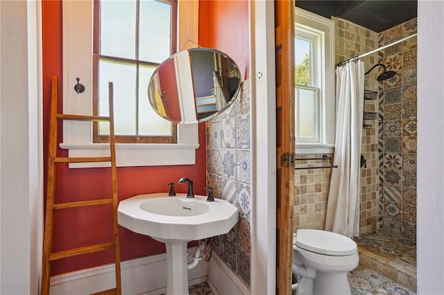 2334 Marengo St, New Orleans, LA 70115 - bathroom with a shower stall, toilet, and tile walls