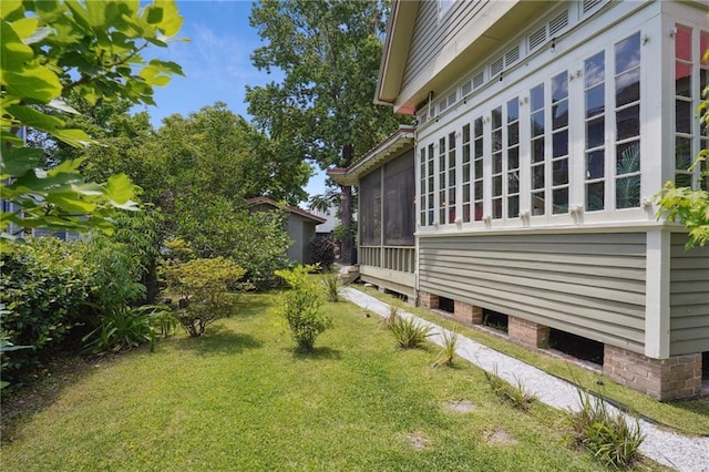 2334 Marengo St, New Orleans, LA 70115 - view of side of home featuring a yard and a sunroom