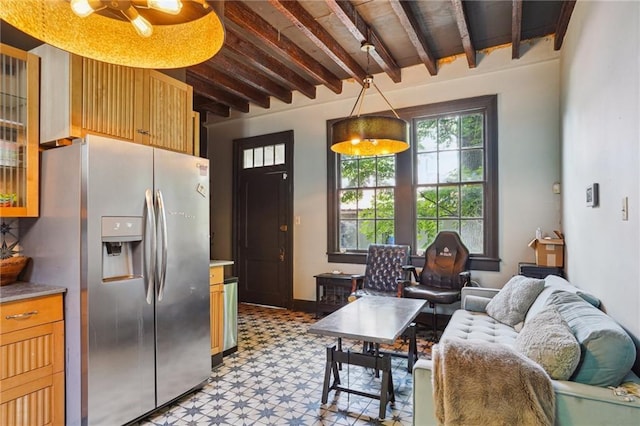 2334 Marengo St, New Orleans, LA 70115 - kitchen with stainless steel fridge, light flooring, beam ceiling, light countertops, and glass insert cabinets